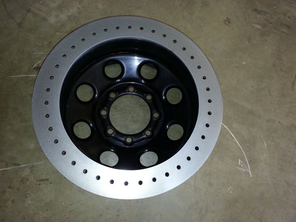 Drilled brake rotor with black center and silver outer ring