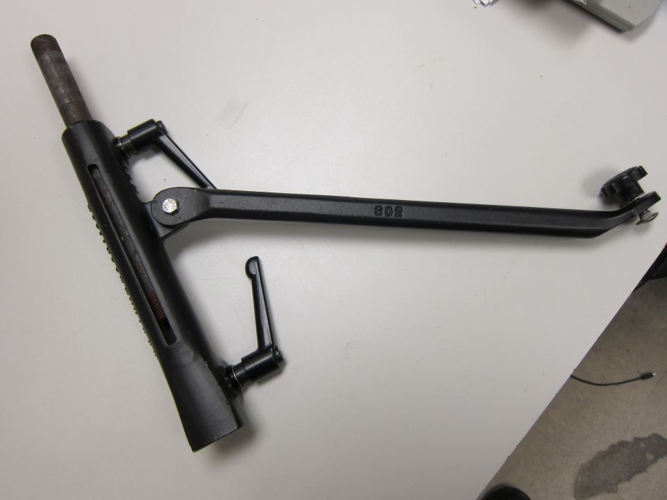 Black adjustable metal bracket with a numbered '302' marking