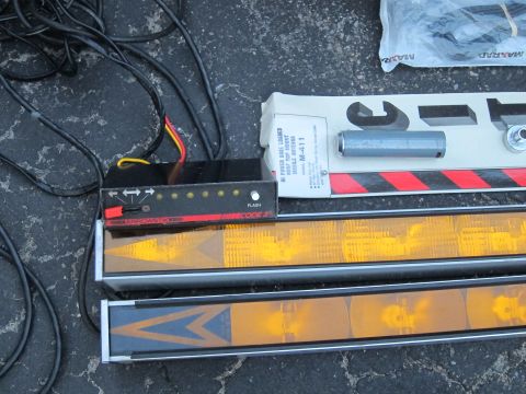 1991 Ford LTD Crown Victoria - Components for an emergency light bar system are laid out on asphalt.