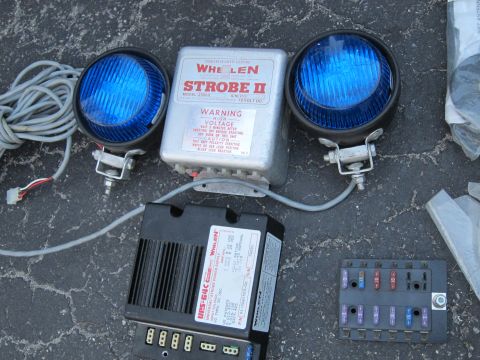 1991 Ford LTD Crown Victoria - Emergency vehicle lighting parts including strobe lights, power supply, and fuse box.