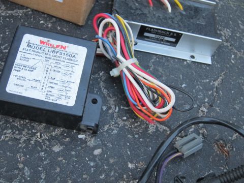 1991 Ford LTD Crown Victoria - Close-up of a Whelen UBF5150A electronic tail light flasher, showing its wiring diagram and associated cables.
