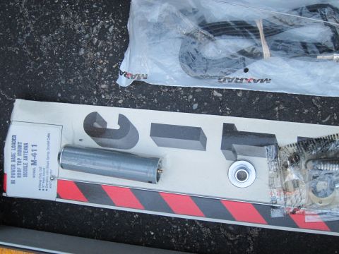 1991 Ford LTD Crown Victoria - The photo shows a boxed mobile antenna and its components, including a base, cable, and mounting hardware.