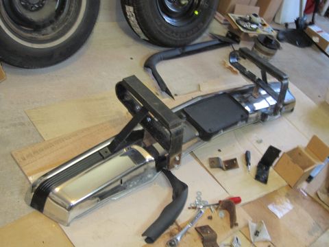1991 Ford LTD Crown Victoria - Front bumper assembly with chrome and black trim, disassembled and laid out with tools.