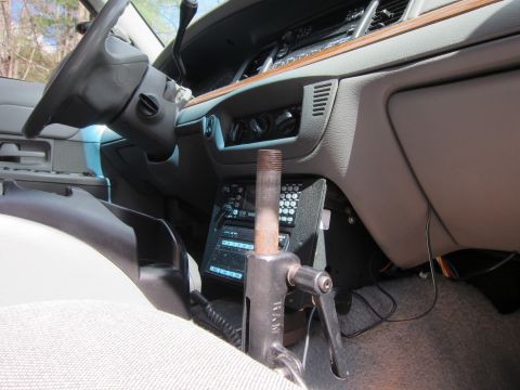 1991 Ford LTD Crown Victoria - The interior of a police vehicle, a radio console and a gear shifter, with a view of the dashboard and steering wheel.