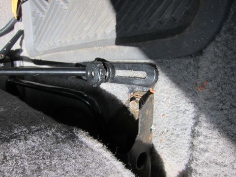 1991 Ford LTD Crown Victoria - Close-up of a seat adjustment mechanism, showing the lever and mounting bracket.