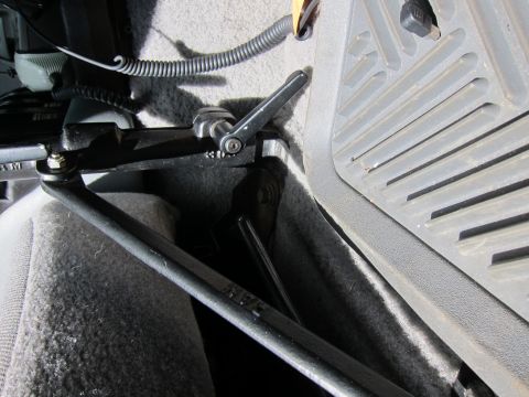 1991 Ford LTD Crown Victoria - Interior view of a metal bracket and lever mechanism in a vehicle.