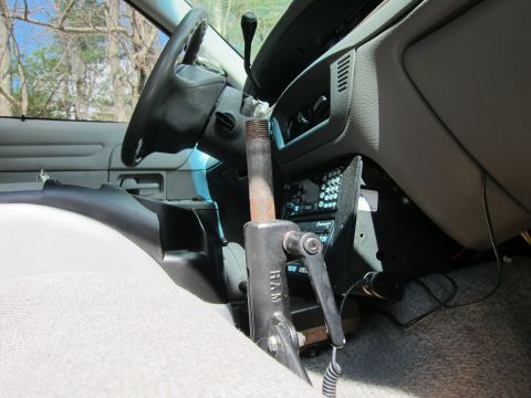 1991 Ford LTD Crown Victoria - The interior of a car shows a steering wheel, dashboard, and a RAM mount device with an aftermarket radio installed.