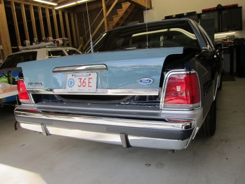 1991 Ford LTD Crown Victoria - Rear view of a Ford Crown Victoria in a garage, with another vehicle visible behind it.