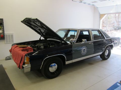 1991 Ford LTD Crown Victoria - This 1991 Ford Crown Victoria LTD police car is in a garage with its hood open.
