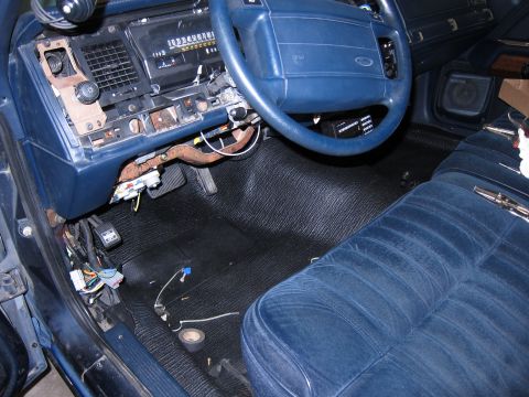 1991 Ford LTD Crown Victoria - The interior of a 1991 Ford Crown Victoria LTD shows a disassembled dashboard and blue velour seats.