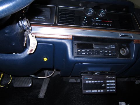 1991 Ford LTD Crown Victoria - The interior of a 1991 Ford Crown Victoria LTD, the dashboard with radio and a Motorola communication device.