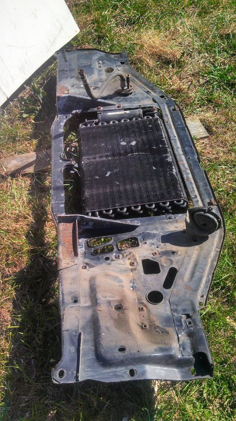 1979 Ford Bronco - Removed radiator support and condenser assembly sits on the grass.