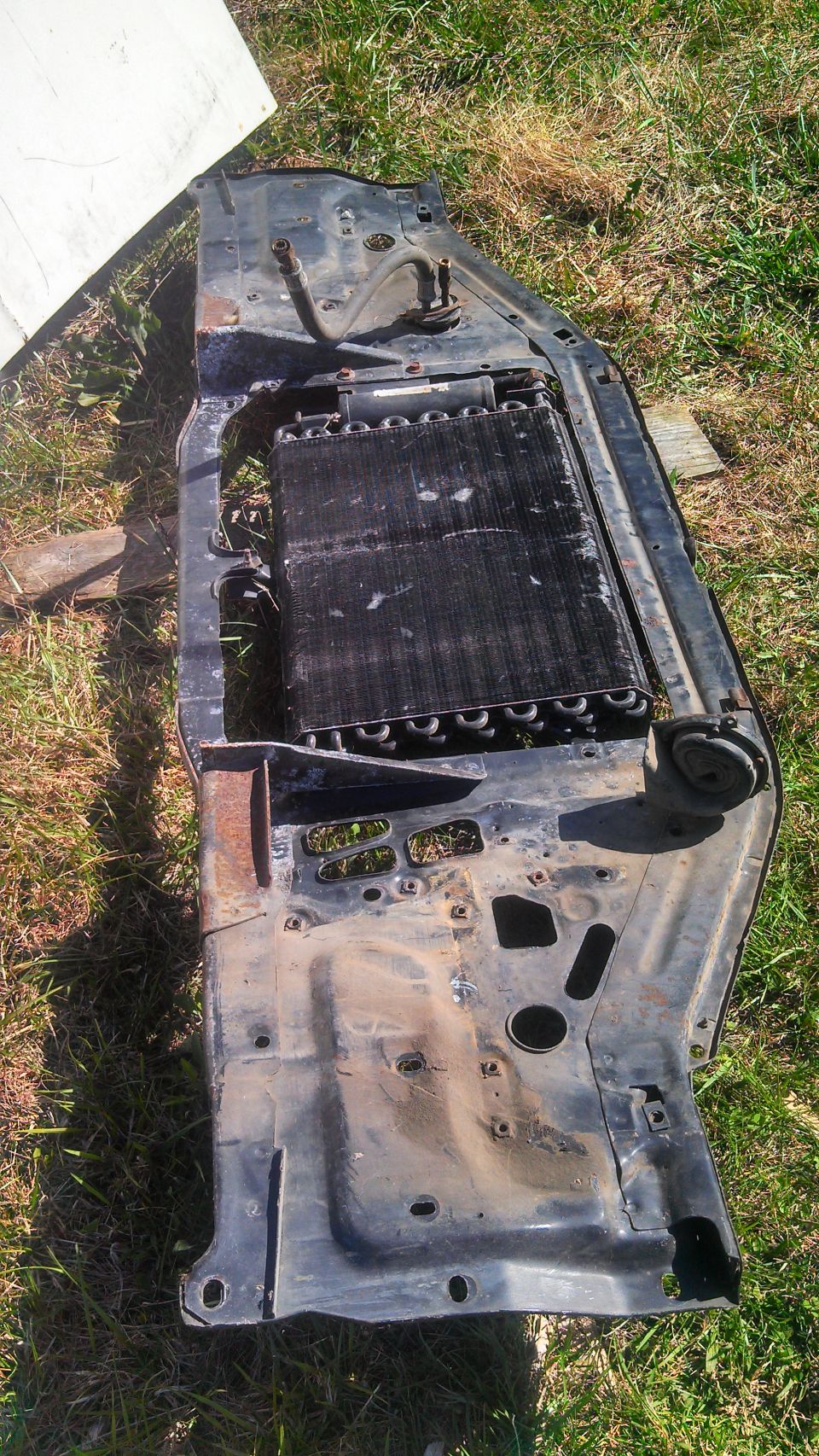 Radiator support assembly with condenser unit removed from a vehicle