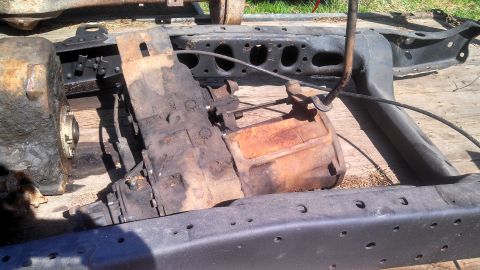 1979 Ford Bronco - Transfer case and differential assembly shown on a vehicle frame, likely for parts.