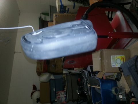 1994 Ford Bronco - A spare tire cover is shown in a cluttered storage area with boxes and equipment.