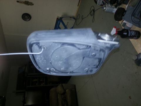 1994 Ford Bronco - A gray car part is shown from the back, with a white wire extending from it.