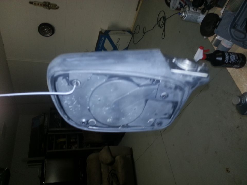 Gray car part with wire, seen from the back