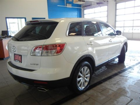 2008 Mazda CX-9 - Rear three-quarter view of a white 2008 Mazda CX-9 SUV parked inside a garage with bright lighting.