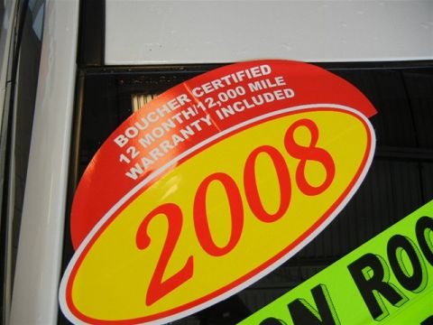 2008 Mazda CX-9 - Dealership sticker indicating a 2008 model year and warranty information is visible on a car window.