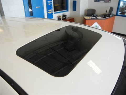 2008 Mazda CX-9 - The image shows the sunroof and roof of a vehicle, with a dealership office visible in the background.