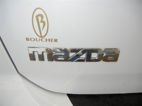 2008 Mazda CX-9 - Close-up of Mazda emblem and Boucher dealership logo on a white vehicle part.