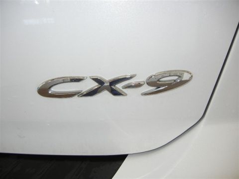 2008 Mazda CX-9 - The chrome CX-9 emblem is affixed to the vehicle's body panel.