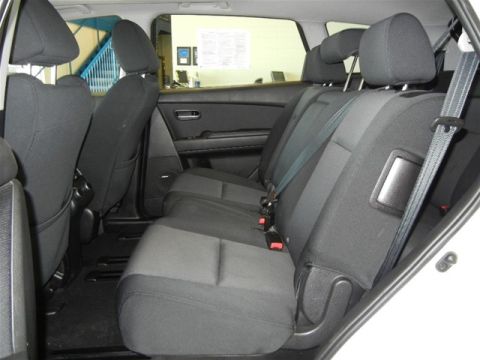 2008 Mazda CX-9 - Rear seating area of a white SUV, showing fabric upholstery and seatbelts.