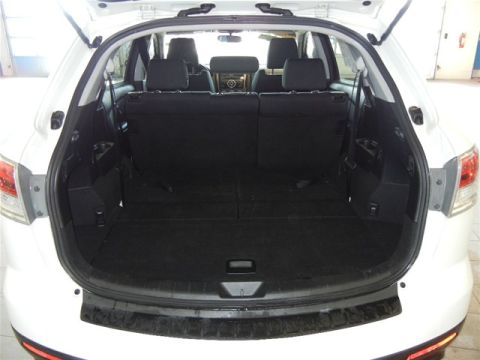 2008 Mazda CX-9 - The spacious cargo area of a white 2008 Mazda CX-9, with the rear seats folded flat for maximum storage.