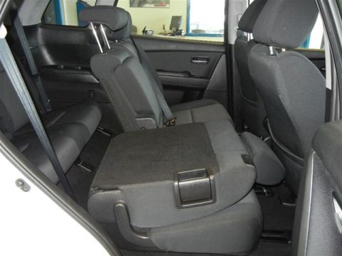 2008 Mazda CX-9 - The interior of a vehicle is shown, focusing on the rear seating area and seatbelts.