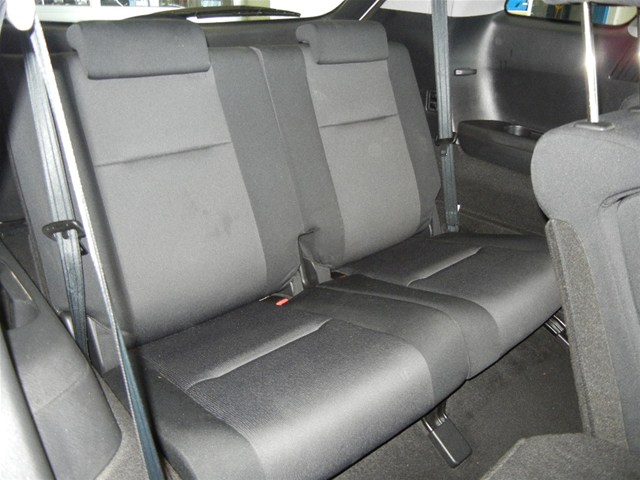 Black fabric rear seats with headrests and seatbelts in a car interior