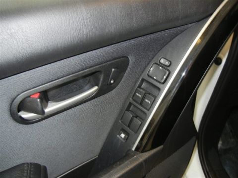 2008 Mazda CX-9 - Interior view of a 2008 Mazda CX-9 door panel, showing the window and lock controls.