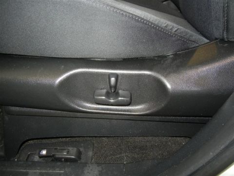 2008 Mazda CX-9 - A close-up view of the seat adjustment controls inside a vehicle.