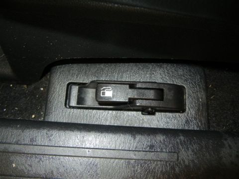 2008 Mazda CX-9 - Interior view of a black fuel door release lever with a gas pump icon.