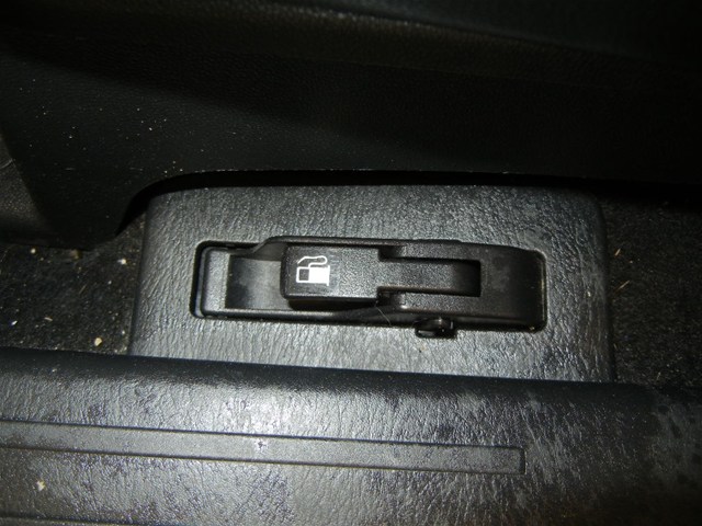 Black fuel door release lever with a gas pump icon, located on the interior floor console