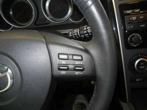 2008 Mazda CX-9 - The interior of a 2008 Mazda CX-9 is visible, focusing on the steering wheel and dashboard controls.