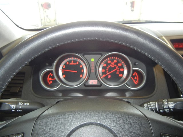 Dashboard of a 2008 Mazda CX-9 showing speedometer, tachometer, and fuel gauges