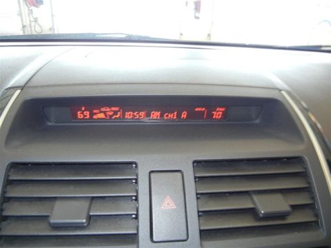 2008 Mazda CX-9 - The digital display on the car's dashboard shows the time, temperature, and radio channel.