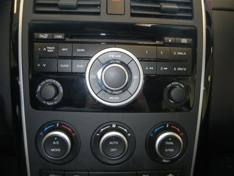 2008 Mazda CX-9 - The center console of a 2008 Mazda CX-9 features a multi-disc CD player and climate control knobs.