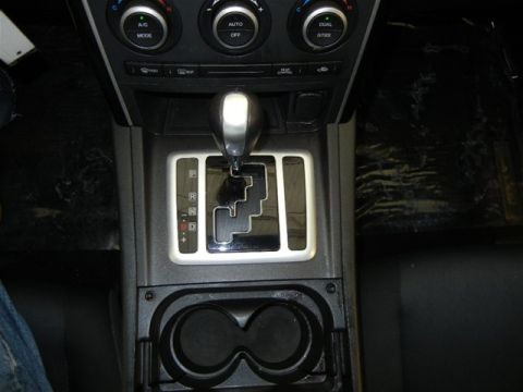 2008 Mazda CX-9 - Interior view of a vehicle's center console, showing the automatic gear shifter and cupholders.
