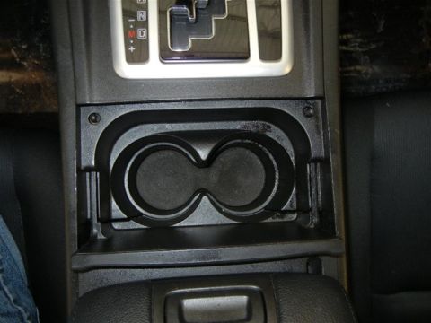 2008 Mazda CX-9 - Interior view of a car's center console, cup holders and the gear selector.