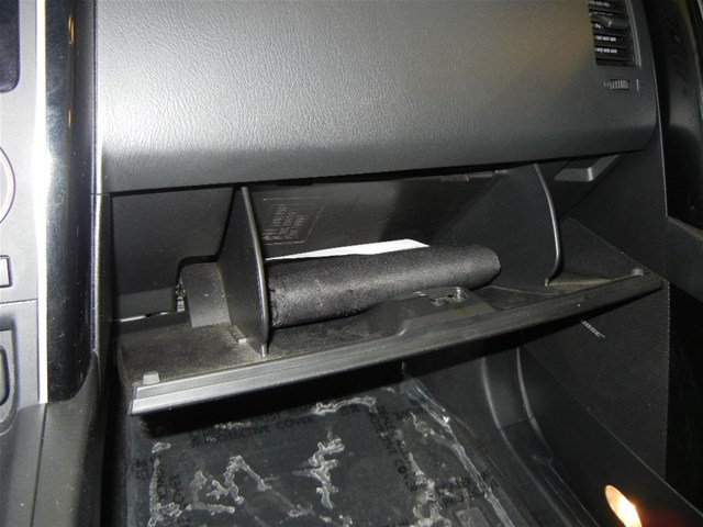 Glove box interior with a rolled document inside