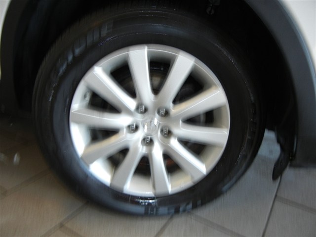 Close-up of a silver alloy wheel with a tire