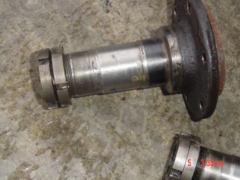 1987 Ford Bronco - Close-up of a vehicle spindle and hub assembly, showing wear and grease.