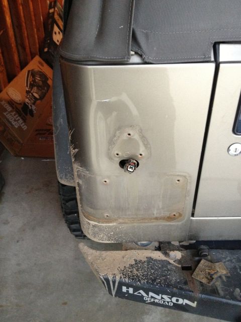 2005 Jeep Wrangler - Rear passenger side of a 2005 Jeep Wrangler, missing its taillight assembly and showing the mounting points.