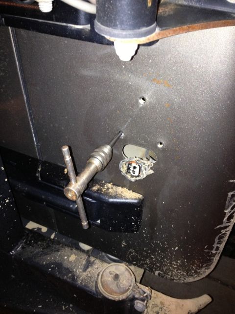2005 Jeep Wrangler - Drill tap tool is used to modify a Jeep body panel, possibly for accessory installation.