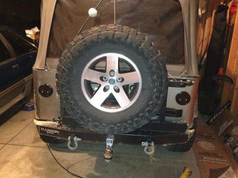 2005 Jeep Wrangler - This Jeep Wrangler features a spare tire mounted on the rear and a custom bumper with tow hooks.