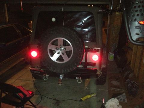 2005 Jeep Wrangler - Rear view of a 2005 Jeep Wrangler with a spare tire mounted on the tailgate.