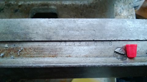 1985 Ford F-150 - Close-up of a metal component showing stamped identification numbers and hardware.