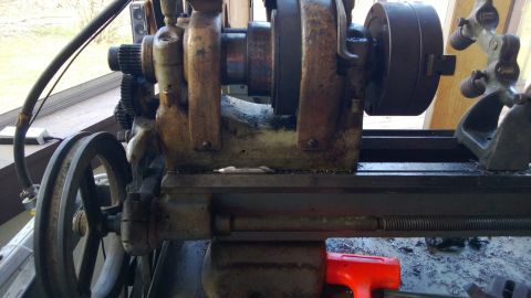1985 Ford F-150 - A close-up view of a metal lathe's headstock, chuck, and drive pulley, showing mechanical components.