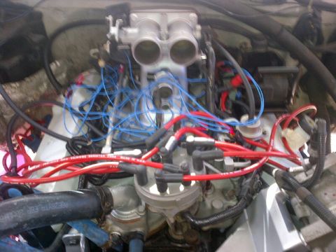 1994 Ford Bronco - Close-up view of a vehicle's engine bay, focusing on the ignition system and fuel intake.